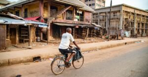 Cyclist Passing by Aiwerioba Oguigo Mansion Shopping Mall in Benin City Nigeria