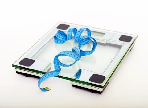 Blue Tape Measuring on Clear Glass Square Weighing Scale