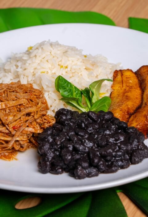 Colorful Pabellón Criollo with rice, beans, plantains, and shredded beef.