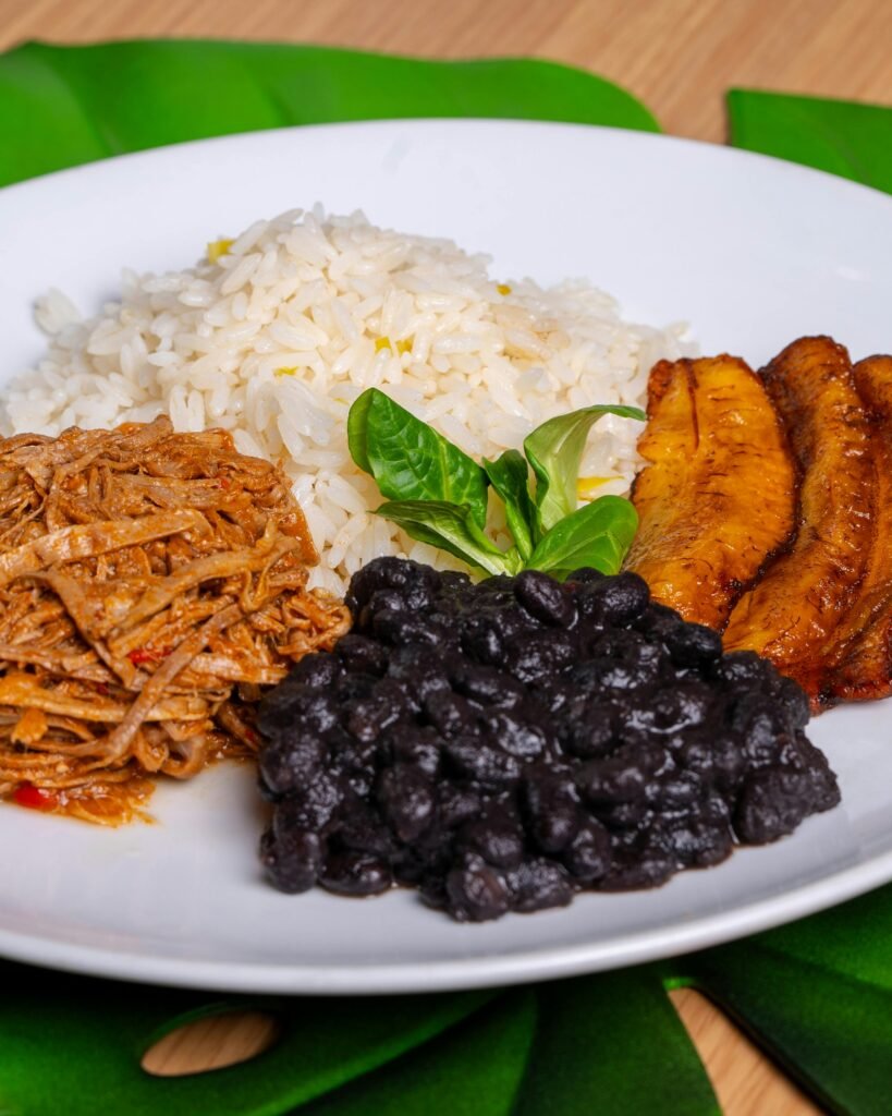 Colorful Pabellón Criollo with rice, beans, plantains, and shredded beef.