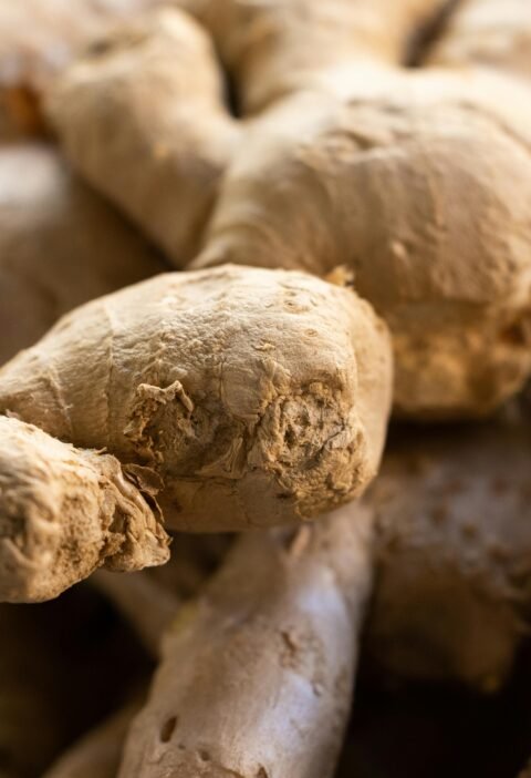 Detailed view of fresh raw ginger roots, showcasing texture and earthy tones. Ideal for food themes.