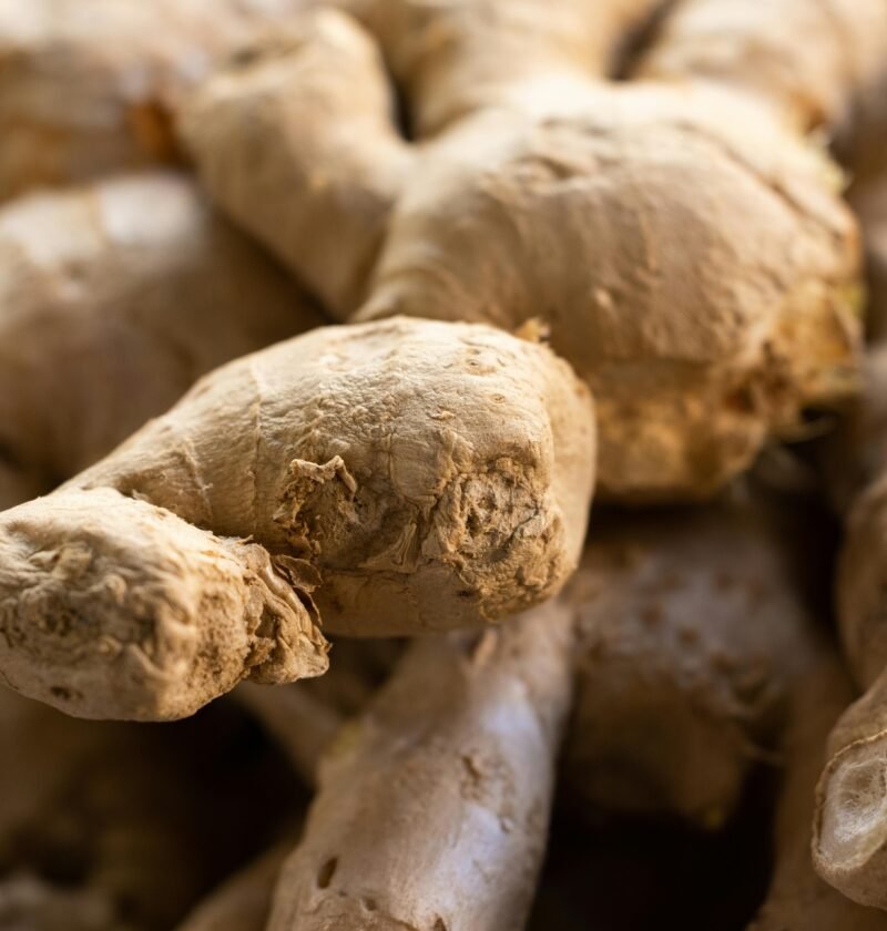 Detailed view of fresh raw ginger roots, showcasing texture and earthy tones. Ideal for food themes.
